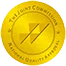 A gold circular seal with the words Joint Commission and National Quality Approval written around the edge, featuring a stylized checkmark design in the center.