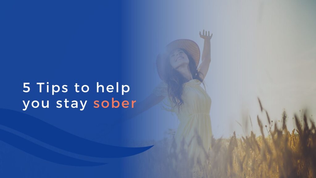 A woman in a yellow dress and hat stands in a field with her arms raised. Blue overlay on the left displays the text: 5 Tips to help you stay sober.