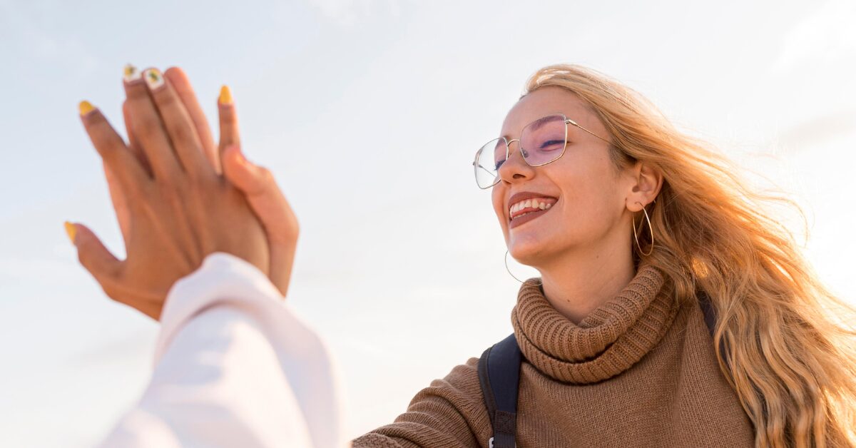 Two people in recovery, high-fiving