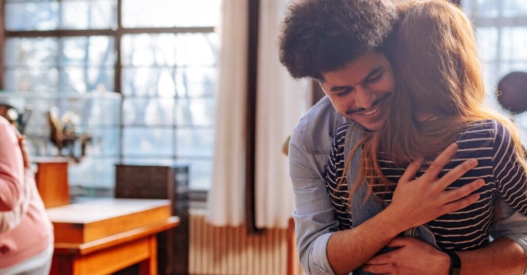 A man and woman embrace in an inpatient rehab facility, for mental health awareness month.