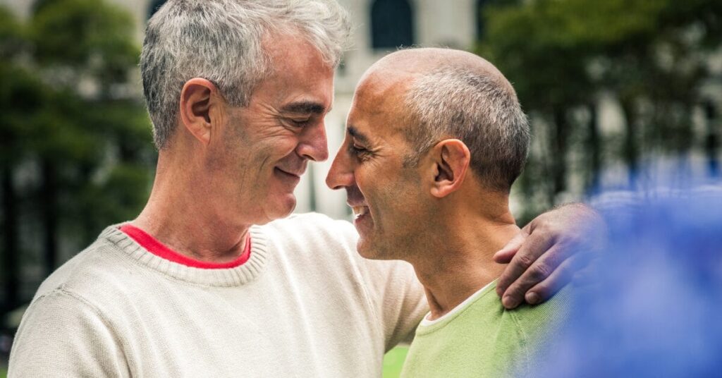 A male couple wearing sweaters embrace outside. LGBTQIA+ individuals are twice as likely to experience substance use disorders when compared to the general population, which is why Dreamlife offers a LGBTQIA+ program for addiction recovery.