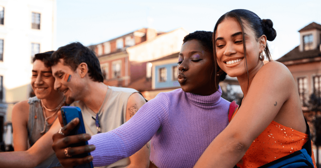 two women smiling, taking a selfie of them celebrating their sober pride.